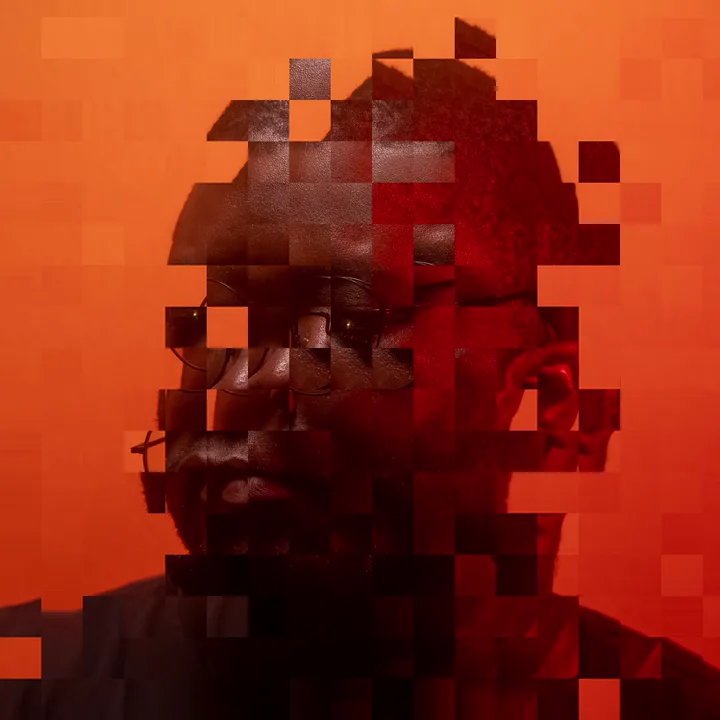 A frame of the Bitrot demo: a portrait breaking apart into a grid of displaced blocks, some carrying image from elsewhere in the frame.